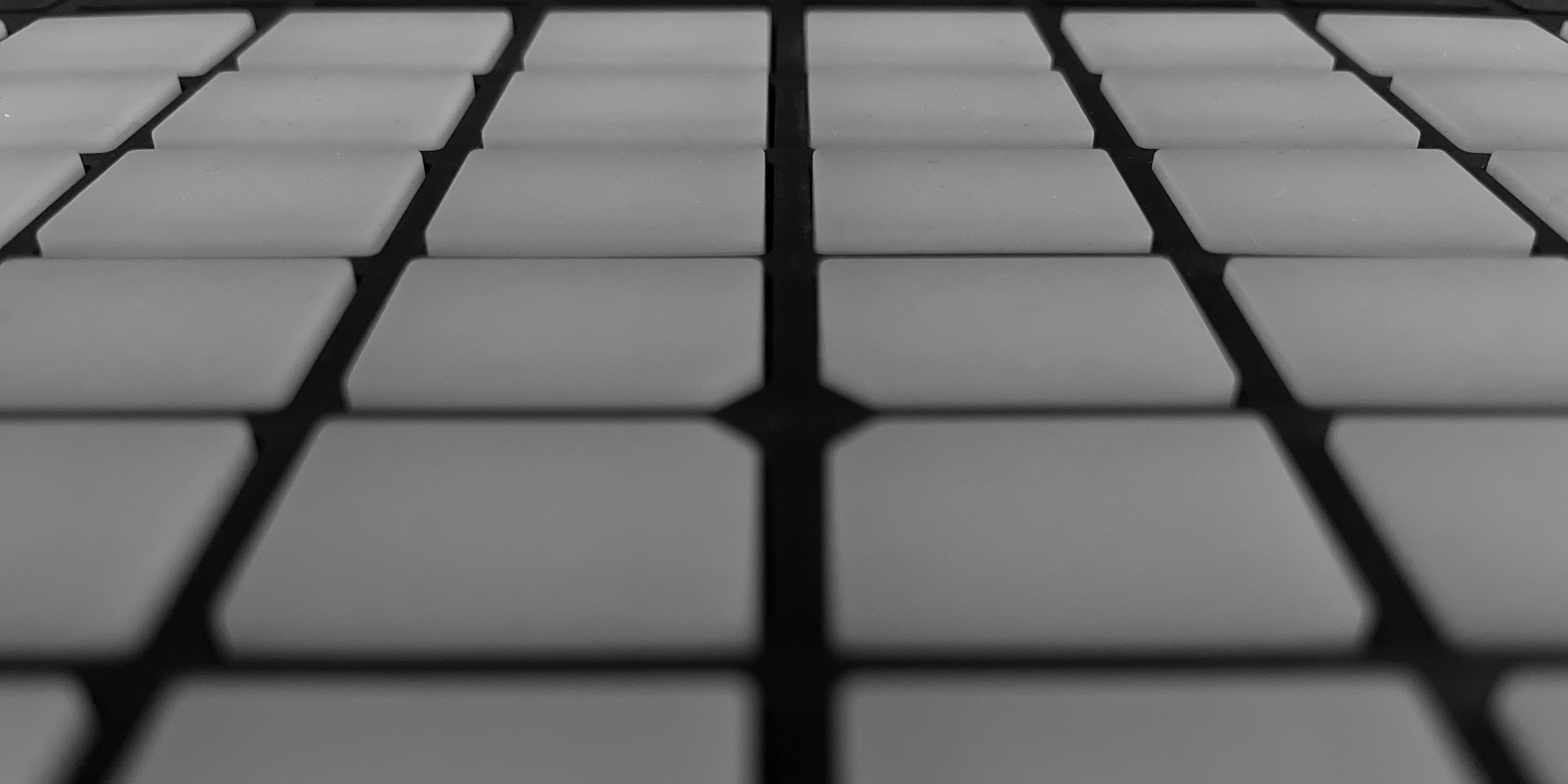 A close-up photograph of the pads on an Ableton Push 2 in grayscale.