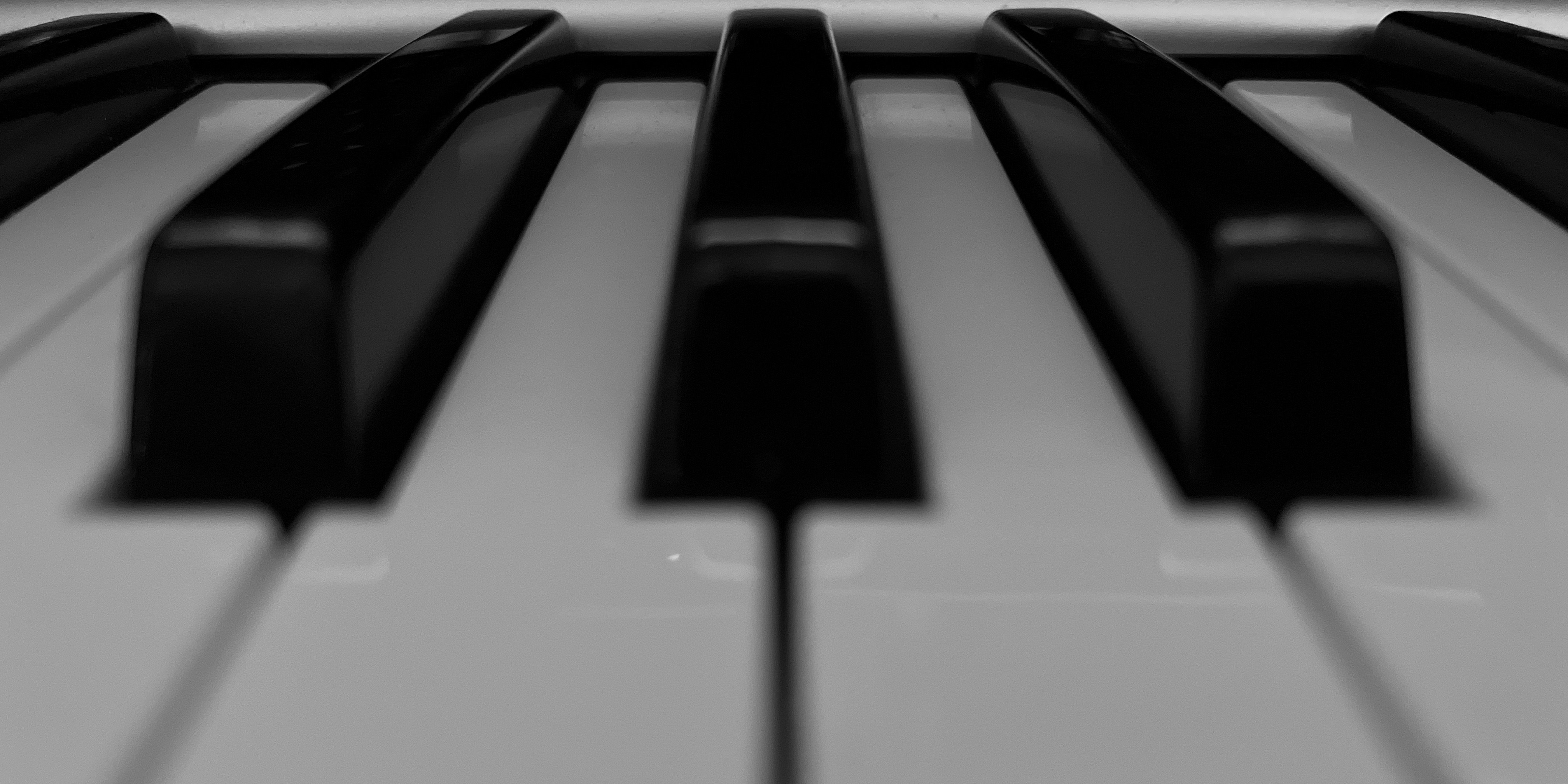 Close up image of a piano keyboard in grayscale