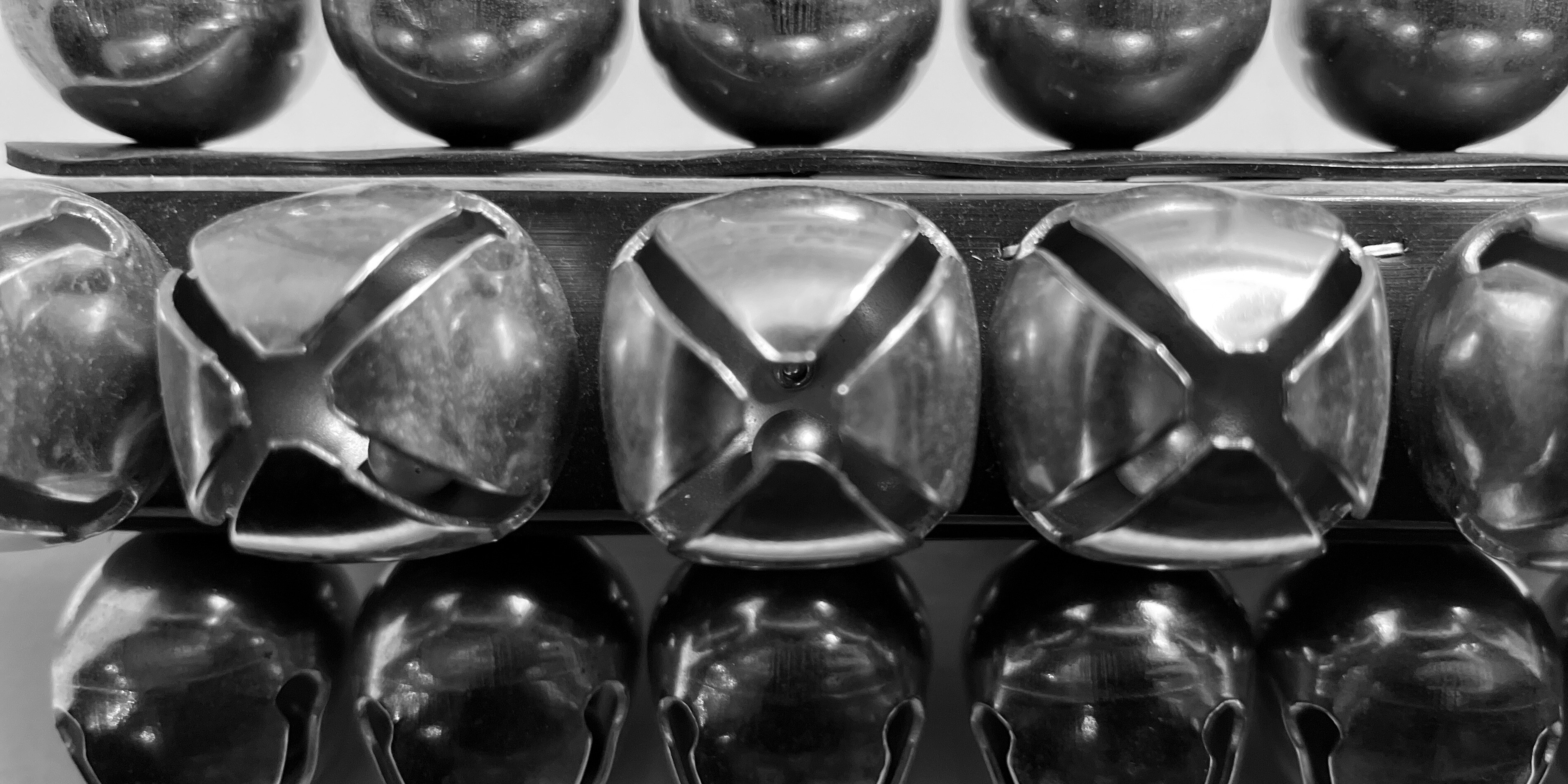 Close-up image of jingle bells in black and white