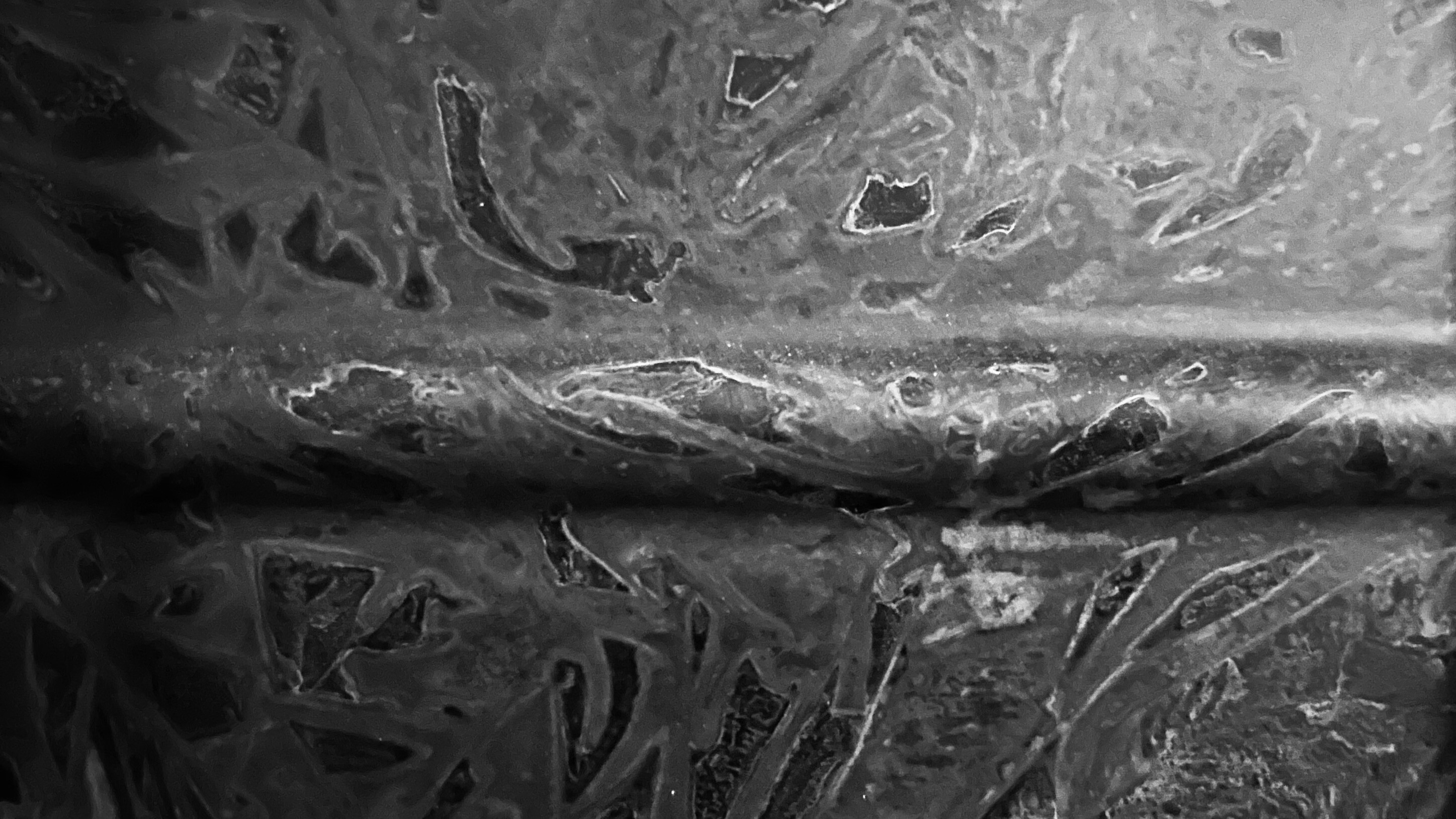 Close up of patina on a metal snare drum in black and white 