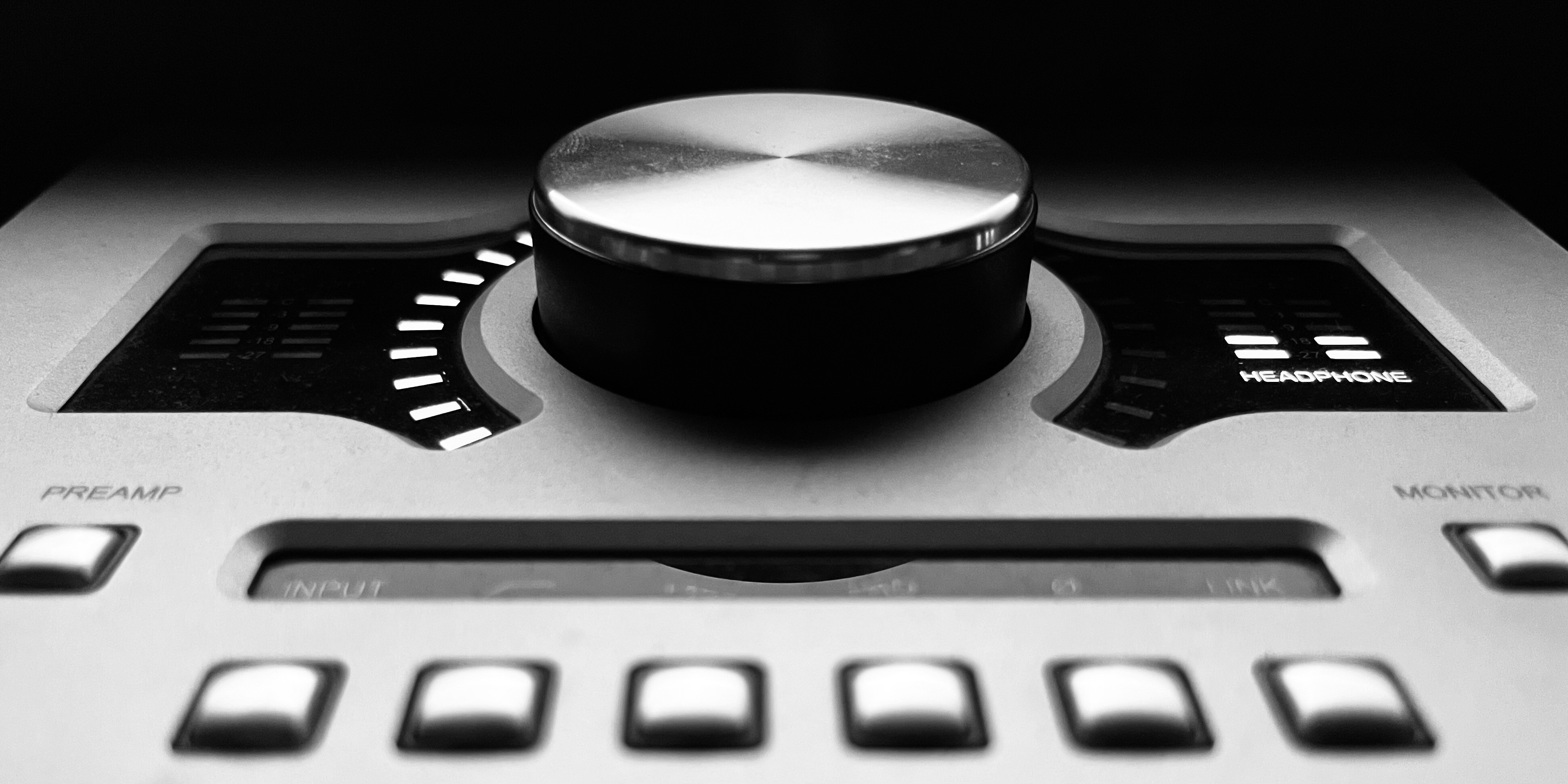 Black and white close-up image of a Universal Audio Apollo Twin audio interface.